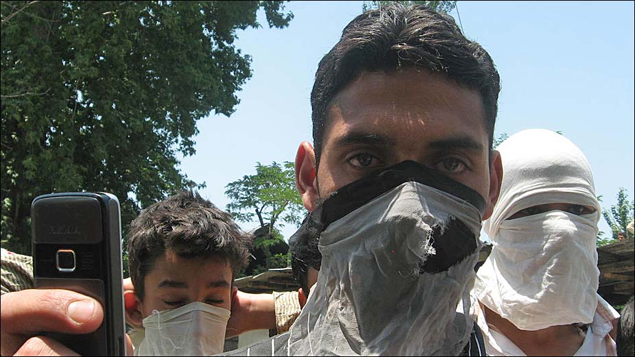 Young Kashmiris wearing masks