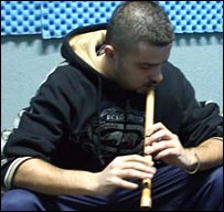 Genc playing an Albanian flute