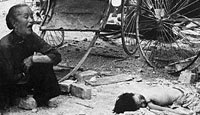 A Chinese grandmother mourns her grandchild after a Japanese bombing raid on Singapore
