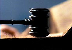An image of an auctioneer banging a gavel.