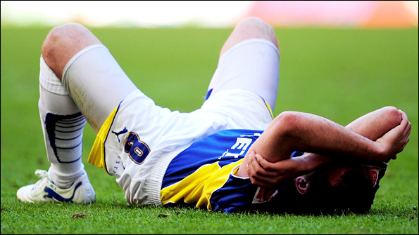 Cardiff striker Michael Chopra sinks to the turf at the end of the game