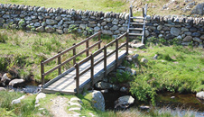 stone wall and wooden bridge