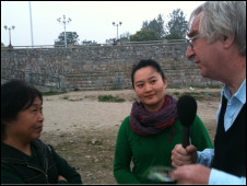 Peter Day with fixer Gemila Li (centre) interviewing a local environmental activist on the banks of the Han River