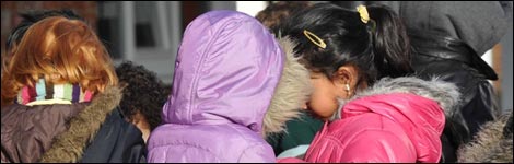 Girls wearing purple and pink coats