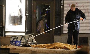 Policeman clearing debris after Sweden suicide bomb