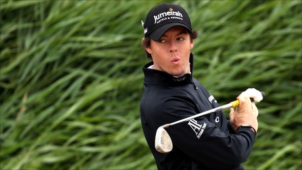 Rory McIlroy watches his ball fly off after a bunker shot