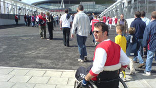 Tim Rushby-Smith, wearing his Arsenal supporter's shirt, approaches the Emirates Stadium
