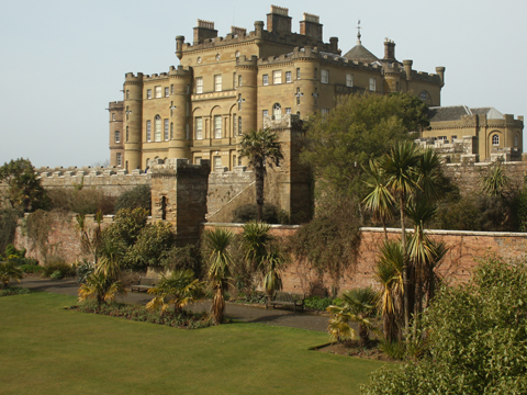 Colour view over formal gardens with palm treets to Culzean Castle.