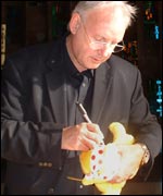 Pete Warterman signing a Pusdey toy 