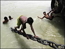 Boys play in the water in an effort to cool off in the river Ganges in Calcutta, India, Friday, May 14, 2010