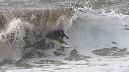 Swansea surfer Lloyd George pulling into a tube during the contest. Image by Claire Beach.