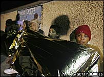 Біженці на Лампедузі ховаються від холоду і дощу плівкою під плівкою