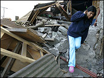Mulher entre escombros em sua casa, em Tocopilla