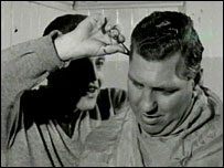 Striker Ernie Hunt cuts manager Bert Head's hair