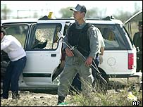 Mexický voják u auta s mrtvými dozorci