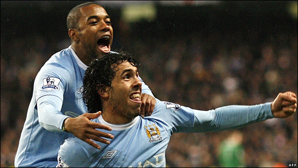 Carlos Tevez celebrates with Robinho