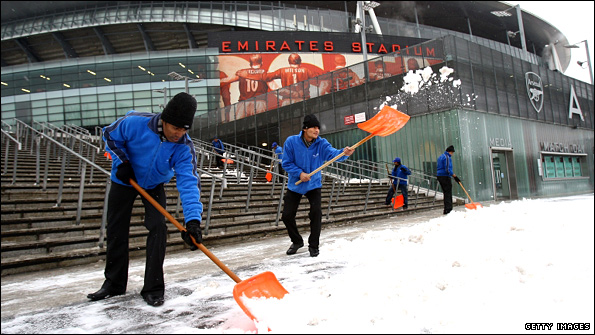 Volunteers clear snow at The Emirates stadium
