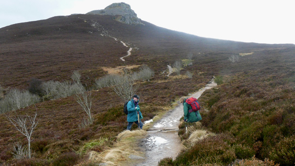 Path continues past workers, up towards summit