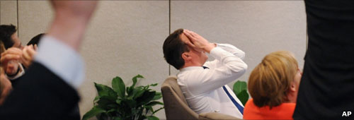 David Cameron with his head in his hands