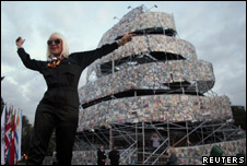 Artist Marta Minujin poses in front of her creation, The Tower of Babel