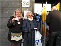 Two women standing 203