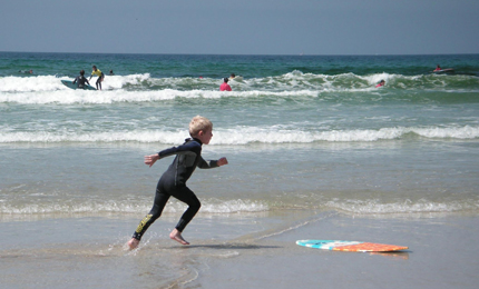 Skim board Simon (6) , masters the art of skim, a bit like a cross between skateboard/surf but with extra chance of face plant in the sand, Baie des Trepasses beach, Brittany, August 2006. Pic: David Gibson