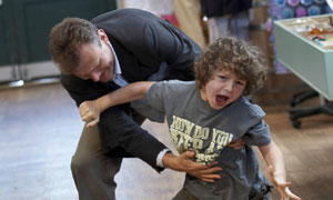 Hugh Dennis grappling with child in Outnumbered