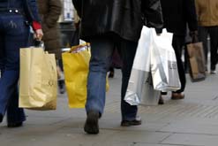 Picture shows shoppers with bags of goods