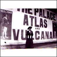 vulcana stands in front of an advert