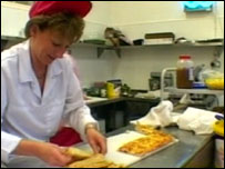 School dinner lady preparing a meal