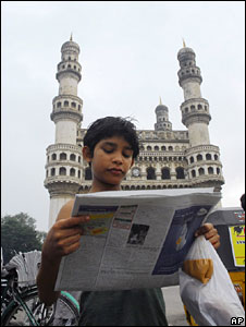 A boy reading a newspaper in Hyderabad, Andhra Pradesh
