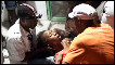 Haitian woman fainting in arms of medic after earthquake