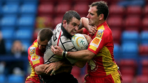Bob Beswick of Widnes takes on Catalan tacklers during a Powergen Cup match in 2006 