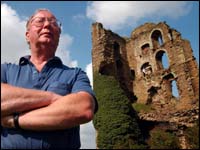 Dr Richard Haworth in front of one of the towers 