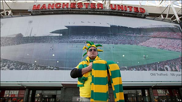 A Manchester United fan sells the scarves outside Old Trafford
