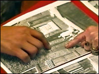 looking at a newspaper