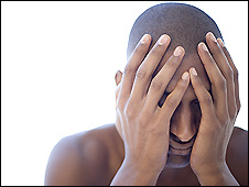 Man holding his head looking depressed
