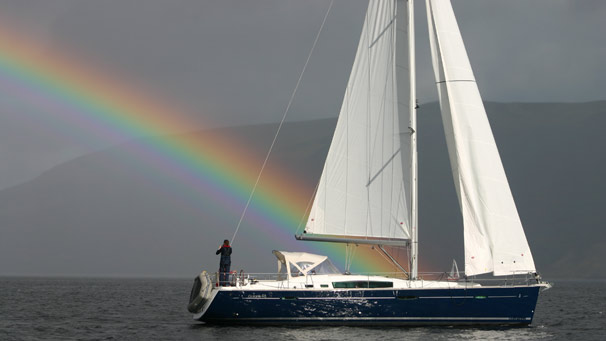 Rainbow behind yacht