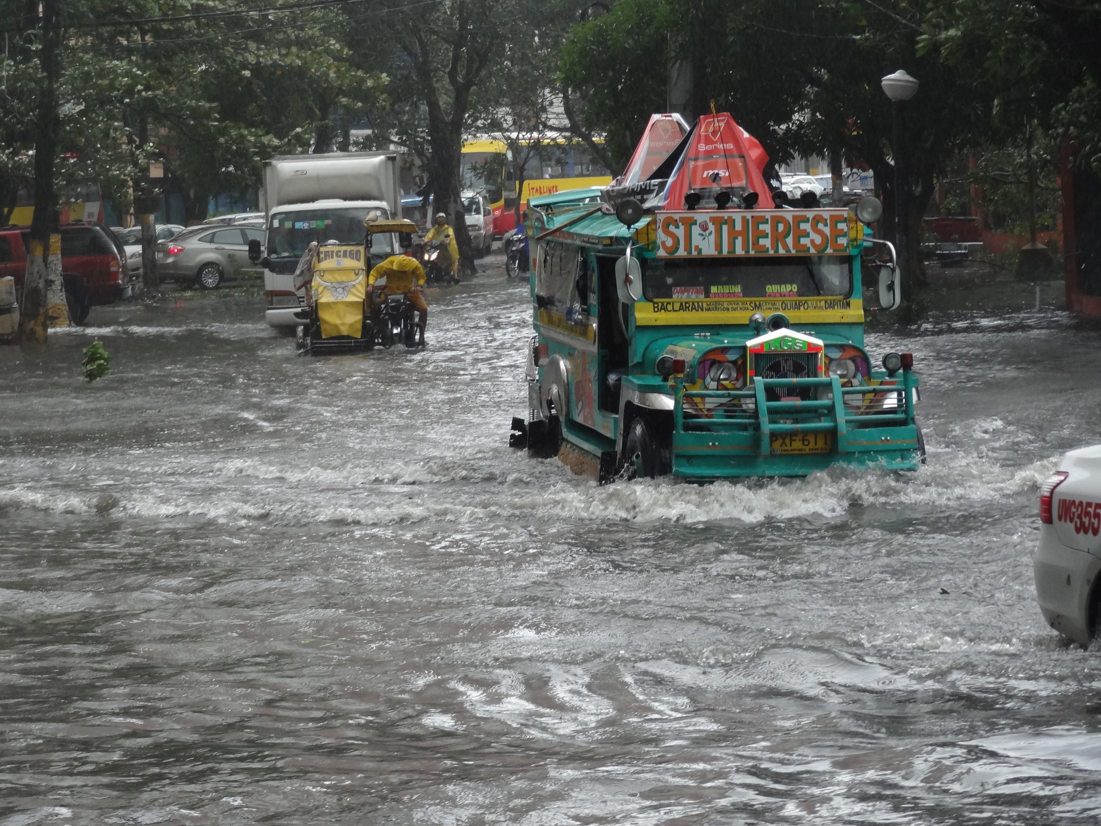 vehicles struggle in the flooded street