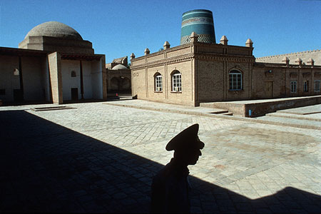 Shadow of a man crossing a square, photo by Tom Ang