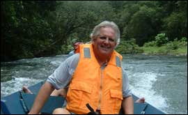 Richard Collinson in a river boat heading for the Brunei Rainforest