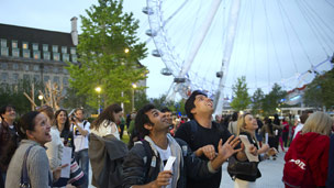 People catching poems underneath the Rain of Poems event