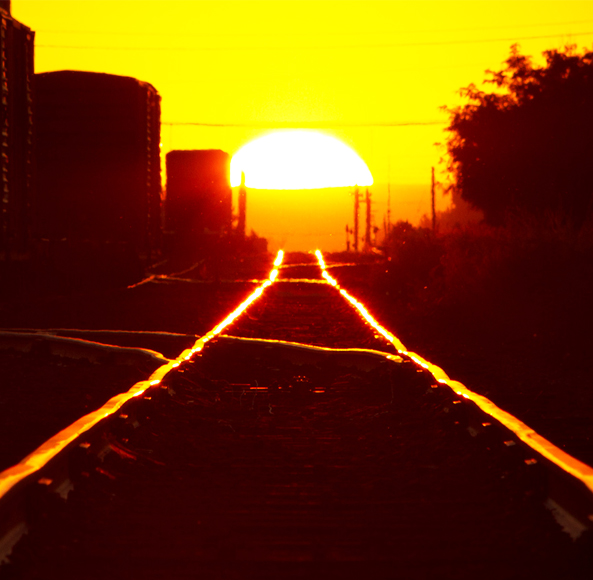 sunset on rail road tracks