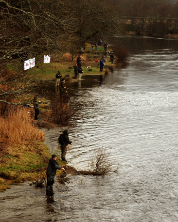 fishermen along river bank