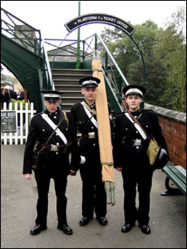 Three men at a railway station 470
