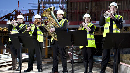 Photograph of the Royal Welsh College of Music & Drama's quintet, Castle Brass, on the site of the new concert hall