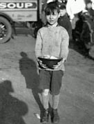 A photograph of a boy by a Salvation Army soup van