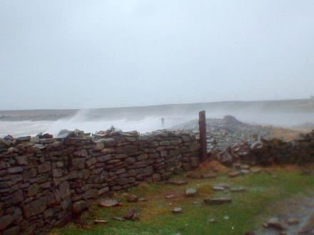Waves splash over the sea bank of the Bay of Brough at 8:58am.