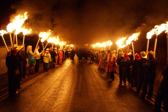 The Guizers with flaming torches, ready to follow the Galley on its final journey.