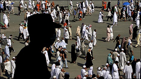 A Saudi policeman keeps watch over Muslim pilgrims near Mecca